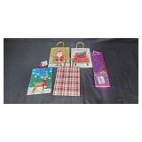 Large Assortment of Christmas Gift Bags, Cards, and Tissue Paper in Storage Bin