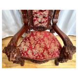 Ornate Antique Carved Throne Chair with Red Floral Upholstery and Lion Head Arms