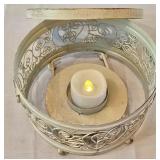LR - Decorative Candle Holder, Vanilla Breve Scented Candle, and Glass Oil Lamp with Floral Foliage Display