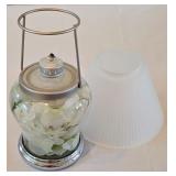 LR - Decorative Candle Holder, Vanilla Breve Scented Candle, and Glass Oil Lamp with Floral Foliage Display