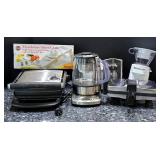 K - Lot of Small Kitchen Appliances and Mandoline Slicer including Breville Tea Maker, Grills, and Food Processor Attachments
