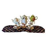 Collection of 3 English Teapots, 4 Bone China Cup and Saucer Sets, and 5 Teapot Print Placemats