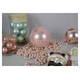 Collection of Pink and Pastel Christmas Ornaments and Santa Figurines