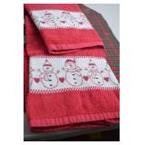 Holiday-themed towels and decorative pillow