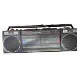 Shop supplies lot includes overhead lights, a display sled, a wire basket, a vintage boom box, and chairs.