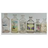 Collection of 12 Antique Glass Water Slide Bottles with Original Labels