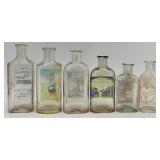 Collection of 12 Antique Glass Water Slide Bottles with Original Labels