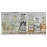 Collection of 12 Antique Glass Water Slide Bottles with Original Labels