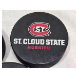 Ryan Poehling Autographed St. Cloud State Huskies Hockey Puck with 2 other Pucks including NCHC Official Game Puck and Herb Brooks National Hockey Center Commemorative Puck