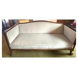 Antique Wood-Trimmed Sofa with Carved Paw Feet and Accent Pillows