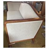 Antique Wood-Trimmed Sofa with Carved Paw Feet and Accent Pillows