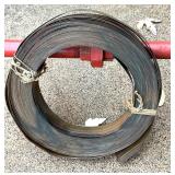 Red Metal Pipe Frame Clothing Stand and Roll of Perforated Metal