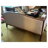 Antique Wood-Trimmed Sofa with Carved Paw Feet and Accent Pillows