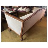 Antique Wood-Trimmed Sofa with Carved Paw Feet and Accent Pillows