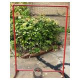 Red Metal Pipe Frame Clothing Stand and Roll of Perforated Metal