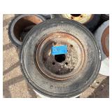 Pallet of Industrial tires and rims, likely for heavy yard equipment