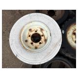 Pallet of Industrial tires and rims, likely for heavy yard equipment