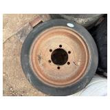 Pallet of Industrial tires and rims, likely for heavy yard equipment