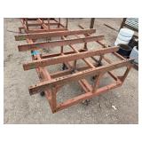 Heavy-duty industrial rolling cart probably designed for transporting pipes or beams 62 ¾” l x 48” w x 33”