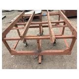 Heavy-duty industrial rolling cart probably designed for transporting pipes or beams 62 ¾” l x 48” w x 33”