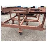 Heavy-duty industrial rolling cart probably designed for transporting pipes or beams 62 ¾” l x 48” w x 33”