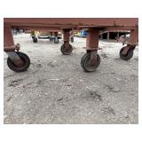 Heavy-duty industrial rolling cart probably designed for transporting pipes or beams 62 ¾” l x 48” w x 33”