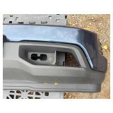 Vehicle Front Bumper Assembly w/ fog light openings, license plate mounting bracket and two-tone color scheme.