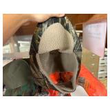 3 shelves of camo/orange hunting gear. Jackets, sweatshirts, hats, foam footballs