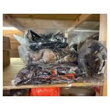 3 shelves of camo/orange hunting gear. Jackets, sweatshirts, hats, foam footballs