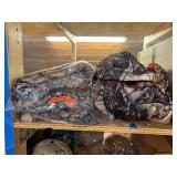 3 shelves of camo/orange hunting gear. Jackets, sweatshirts, hats, foam footballs