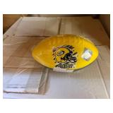 3 shelves of camo/orange hunting gear. Jackets, sweatshirts, hats, foam footballs