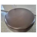 A Modern Round Brown Leather Coffee Table / Ottoman by Room and Board.