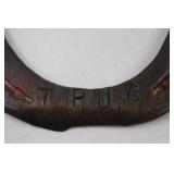 Decorative horseshoe with musical notes and TPJ initials
