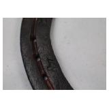 Decorative horseshoe with musical notes and TPJ initials