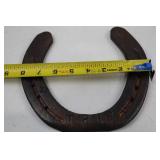 Decorative horseshoe with musical notes and TPJ initials
