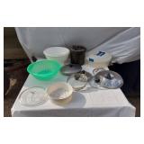 Household kitchen items including mixing bowls, colander, and pot lids