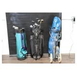 Collection of Vintage Golf Clubs with Bags and Pull Cart