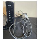 Collection of Xfinity Modems, Cisco Cable Boxes, USB Charger, Remotes, and Decorative Clock