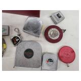 Collection of Vintage and Modern Tape Measures with Metal Storage Box