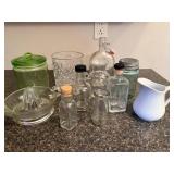 Collection of Vintage Glass Jars, Bottles, Juicer, and White Pitcher
