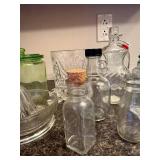 Collection of Vintage Glass Jars, Bottles, Juicer, and White Pitcher