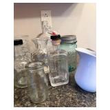 Collection of Vintage Glass Jars, Bottles, Juicer, and White Pitcher