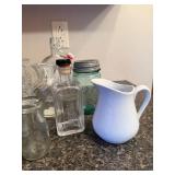Collection of Vintage Glass Jars, Bottles, Juicer, and White Pitcher