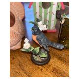 Assorted Collectibles: Porcelain Dolls, Glass Hen Dish, Birdhouse, and Decorative Figurines