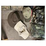 Assorted Hunting Gear Collection with Vests, Caps, Camo Jacket, and Carry Bags