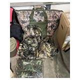 Assorted Hunting Gear Collection with Vests, Caps, Camo Jacket, and Carry Bags