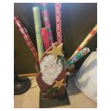 Collection of Holiday Wrapping Paper Rolls and Wooden Santa Holder