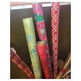 Collection of Holiday Wrapping Paper Rolls and Wooden Santa Holder