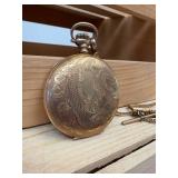 Working Hampden railroad pocket watch with engraved cabin motif
