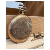 Working Hampden railroad pocket watch with engraved cabin motif